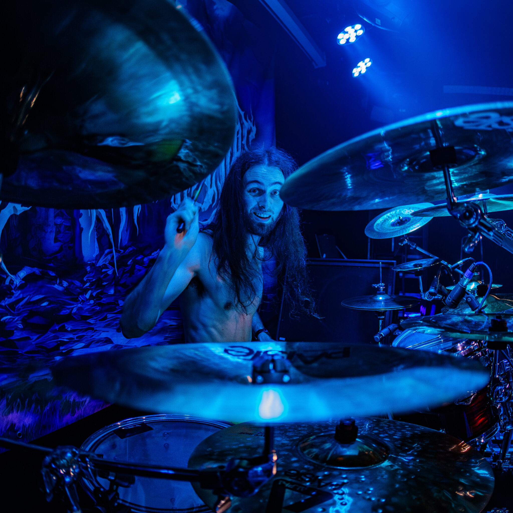 Donny Reiher drumming live under blue stage light